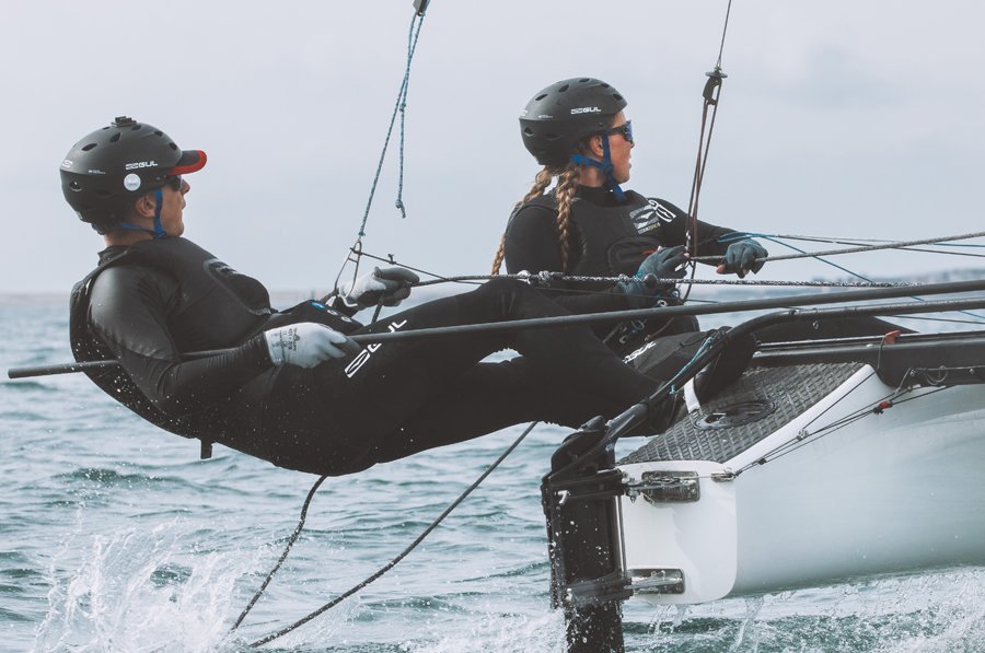 two people in gul wetsuits sailing, click for juniors